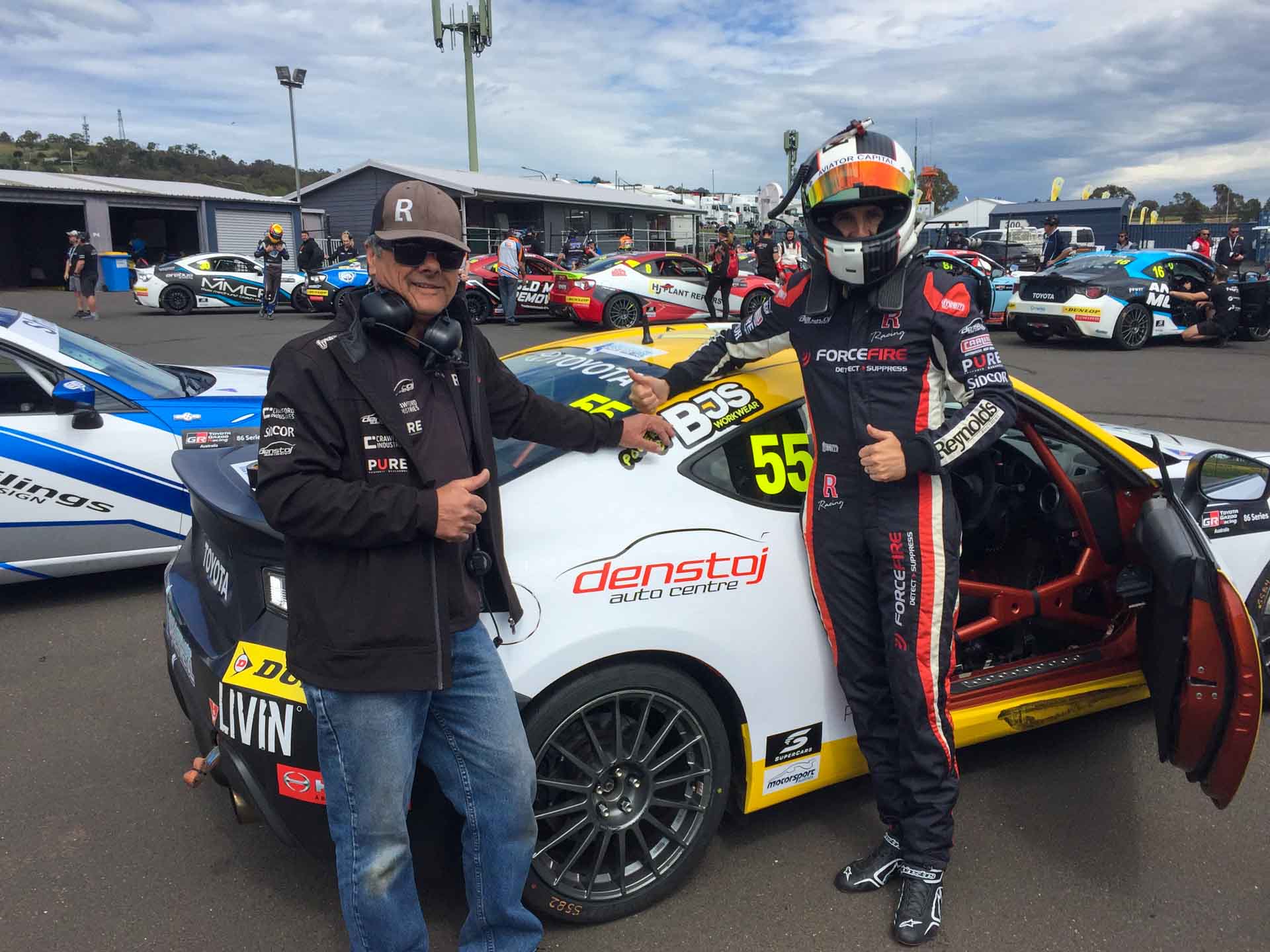 Denstoj-liveried Toyota 86 race car with its driver and crew in the Bathurst paddock
