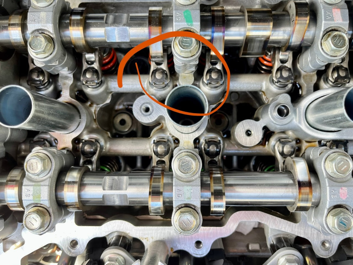 Top view of a GR Yaris G16E-GTS cylinder head with Denstoj rocker retainers fitted, circled in orange