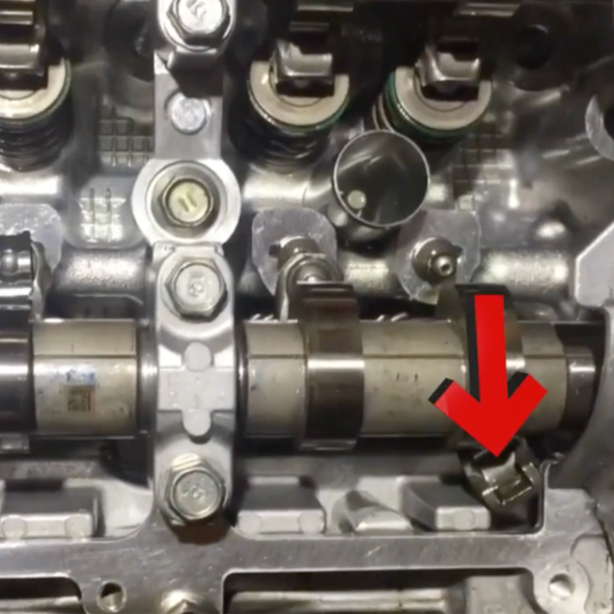 Subaru FA20 valvetrain with an arrow pointing to a rocker arm