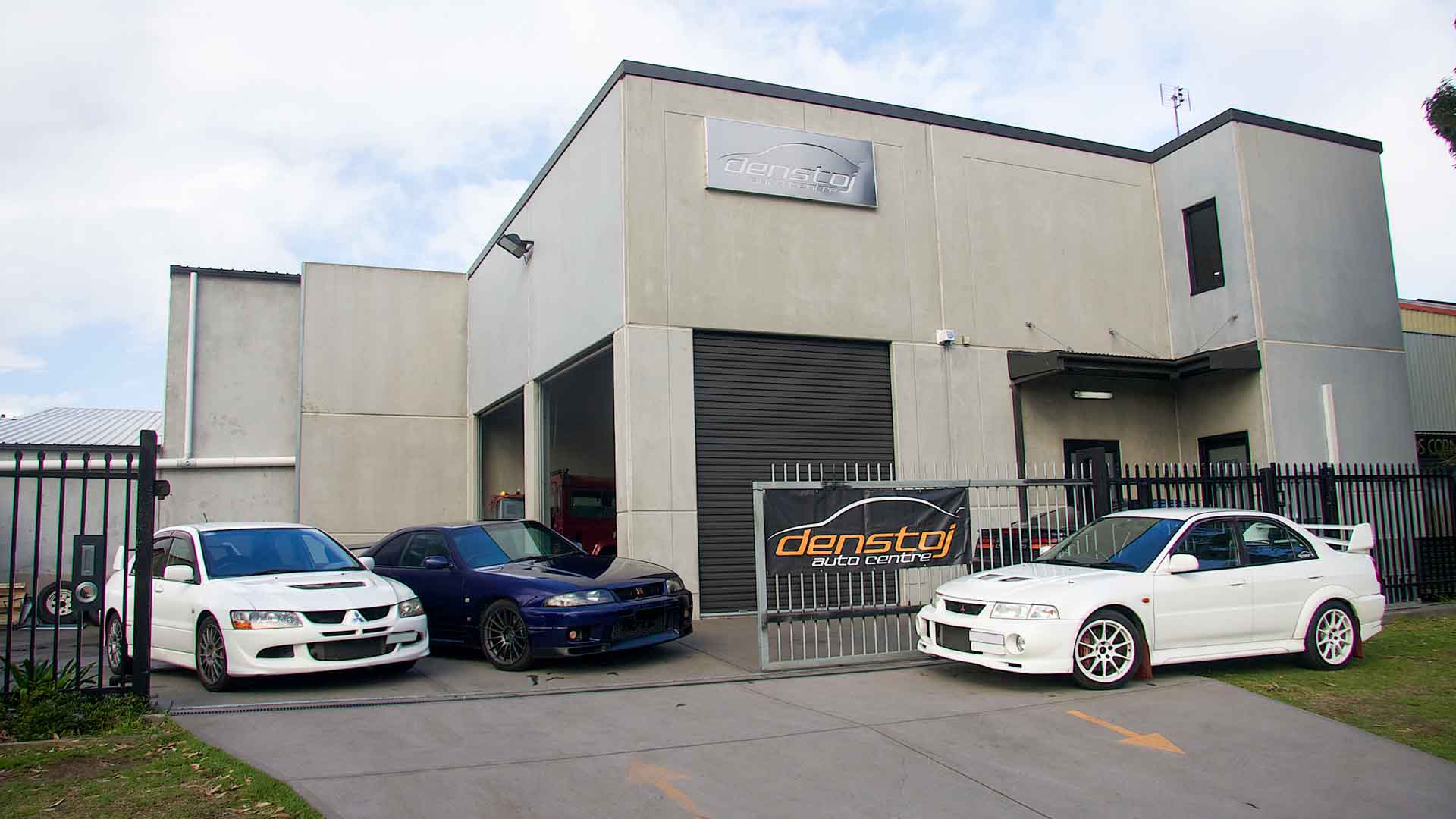 Denstoj workshop at 12 Elizabeth Street, Carrington, with two Mitsubishi Evos and a Nissan Skyline R33 GT-R out front