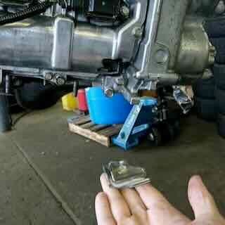 Rocker arm that came out of a Toyota 86 engine, held in a hand
