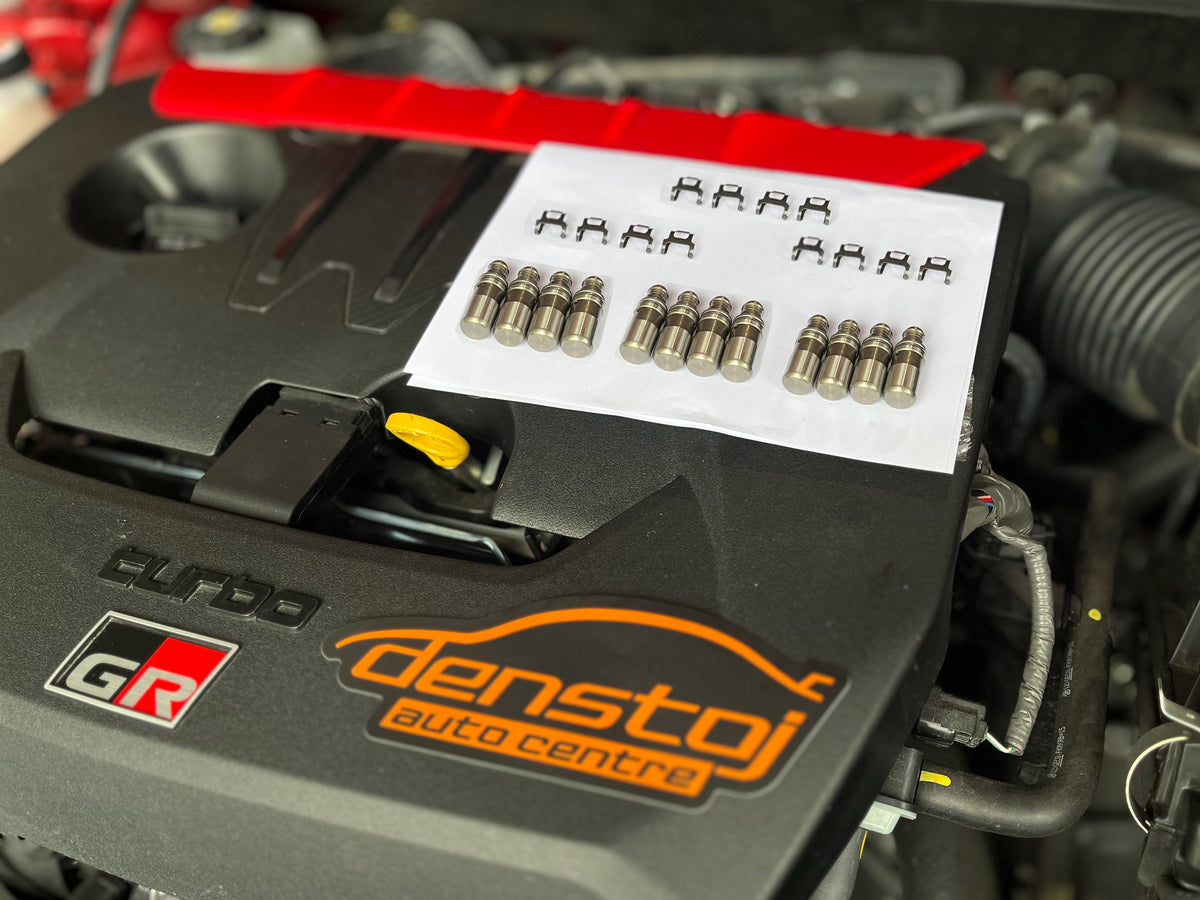 Denstoj G16E-GTS kit of 12 hydraulic lash adjusters and 12 rocker retainer clips on a GR Yaris engine cover